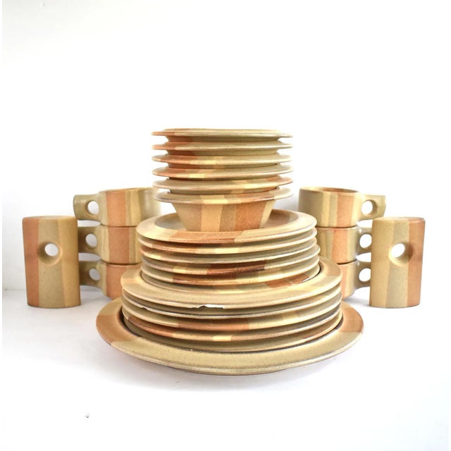 A collection of mid-century heavy stoneware dinnerware designed by Jim McBride with the Fabrik (Seattle) mark in the...