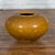 A large Chinese vintage porcelain low squat planter from the 20th century, with mustard color glaze and generous, tapering...