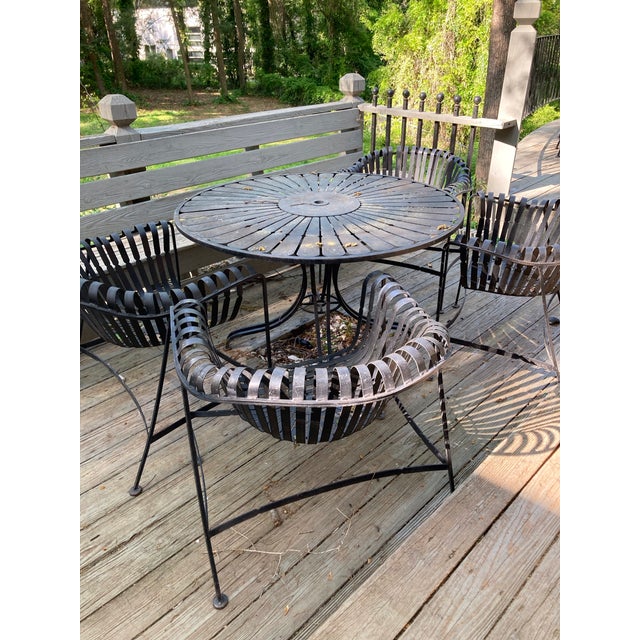 Gorgeous MCM time-capsule painted wrought iron, garden patio dining set with round, sunburst table and four strap iron...