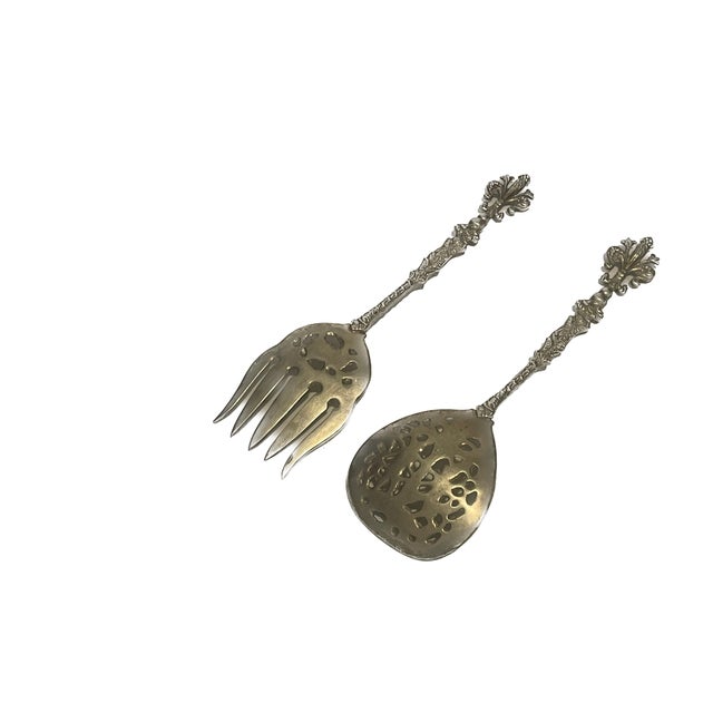 A spectacular vintage pair of Italian silver-plated salad serving utensils, heavily detailed with classic Grand Tour and...