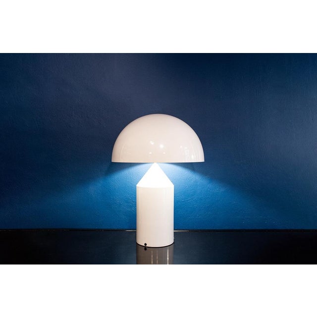 Table lamp in lacquered metal. Atoll model Designer Vico Magistretti Oluce manufacturer Year 1977 This piece has an...