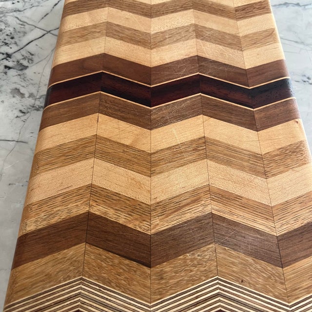 Chevron Multi Hardwood & Exotic Wood Rectangular Cutting Board with Rubber Button Feet by David Levy of Davis, California....