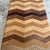 Chevron Multi Hardwood & Exotic Wood Rectangular Cutting Board with Rubber Button Feet by David Levy of Davis, California....
