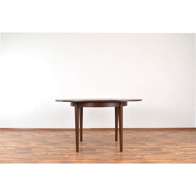 This round dining table was produced in the 1960s in Poland by Jarocińskie Fabryki Mebli. The table is veneered with oak...