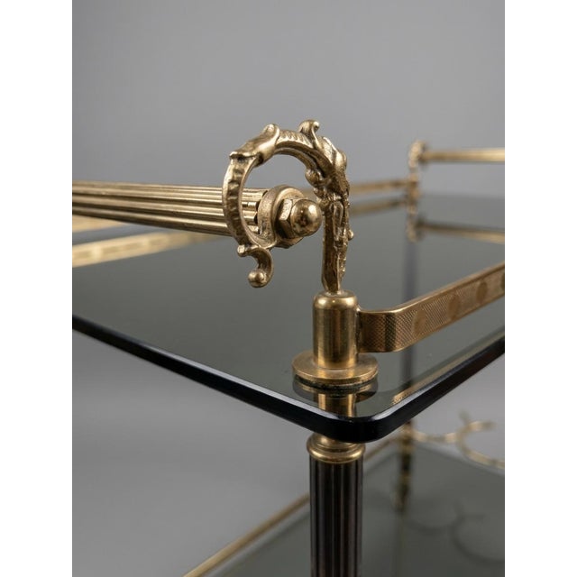 A seriously chic slice of vintage glam, this Hollywood Regency brass and smoked glass trolley brings all the low-lit...