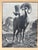 A vintage black and white photograph of a bighorn ram in alpine terrain, presented in its original walnut-tone frame with...