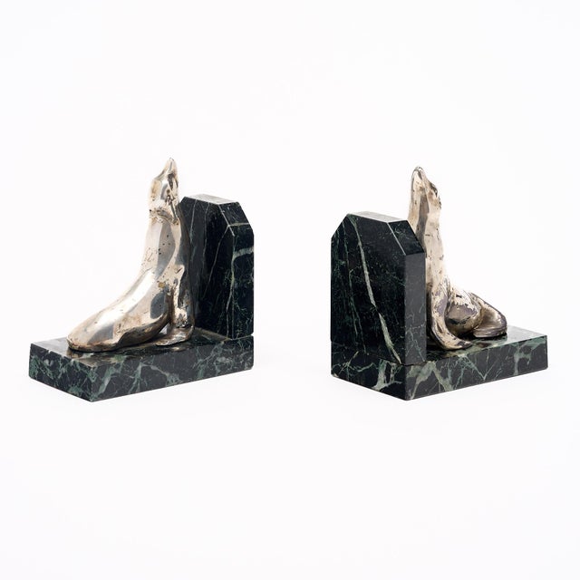 Bookends from France made with “Pietra Verde” green marble bases and showcasing silver plated seal sculptures. They are in...