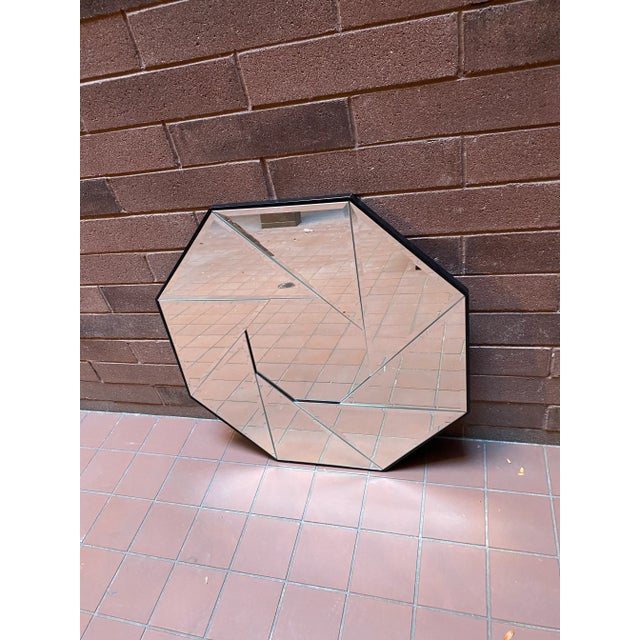1970’s Octagonal Camera Iris Blade Mirror. Features beveled edges and black wood frame. Reminiscent of a camera lens...