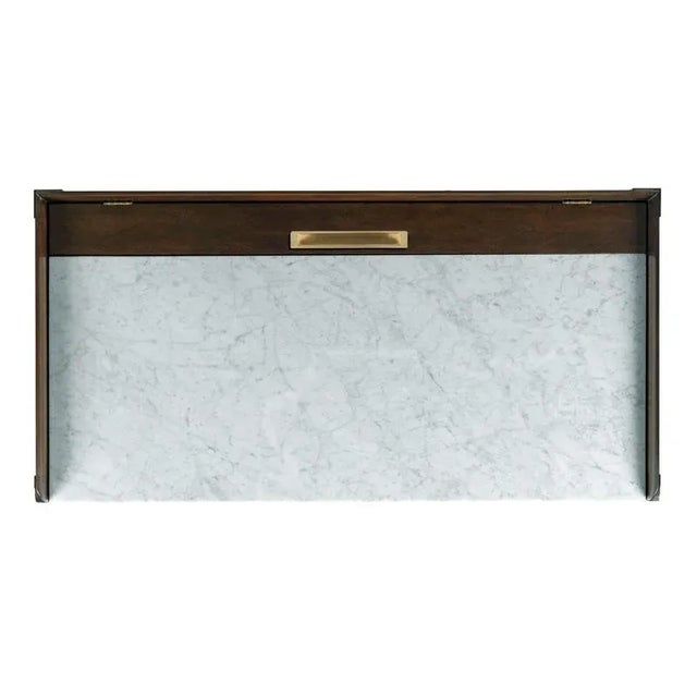 An elegant petite writing table that is perfect at bedside with a carrara marble top over squared tapering posts that...