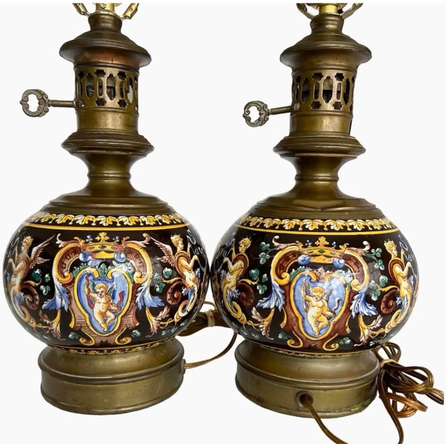 This decorative pair of antique French faience oil lamps was produced by the Faïencerie de Gien in the late 19th century...