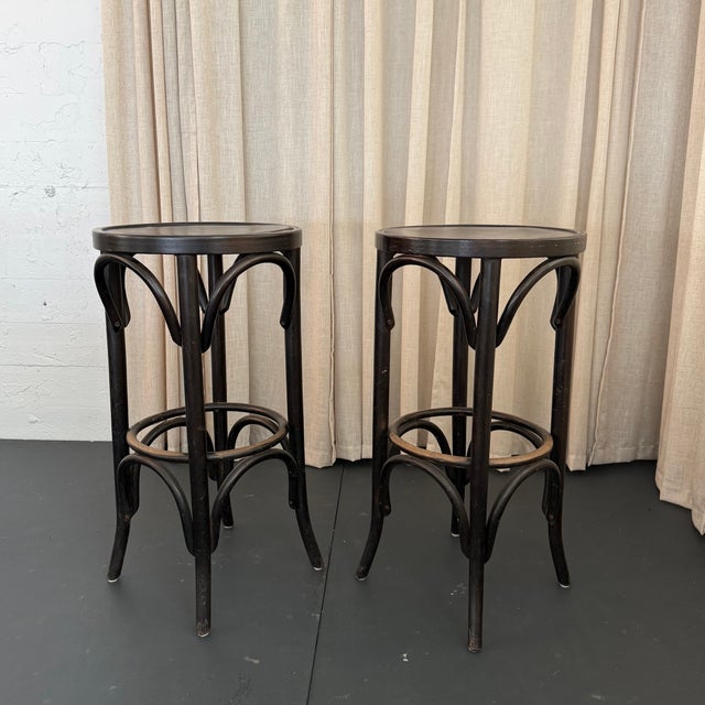 This classic pair of Thonet-style bar stools circa the 1940s showcases the timeless beauty of European craftsmanship with...