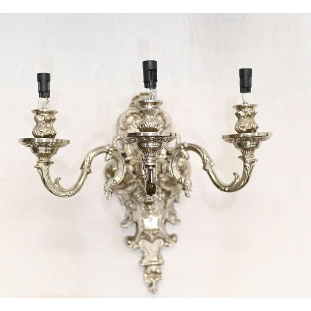 Gorgeous pair of silver finished bronze sconces or wall lights in the Regency manner Three branches to each with ornate...