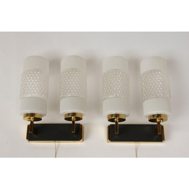 Set of two mid-century modern wall lights, made in Germany in the 1960s. Pressed glass on a metal base. Manufacturer:...