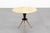Elegant coffee table with a circular light marble top and a central wooden stand with three brass legs. Attributable to...