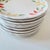 Elevate your tablescape with this charming set of nine vintage salad plates from the historic Syracuse China company. Made...
