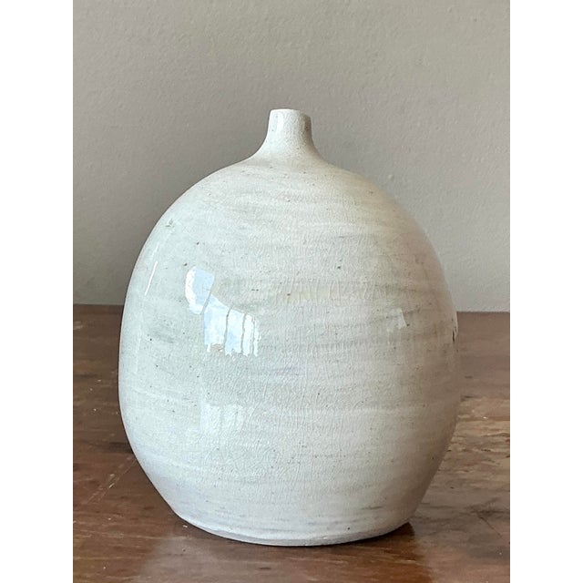 Embrace the understated elegance of this Vintage Boho Glazed Ceramic Bud Vase, a charming testament to artisan...
