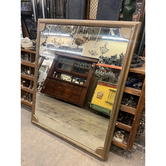Elevate your space with this exquisite vintage mirror boasting a captivating bronze finish with hints of rich red peeking...