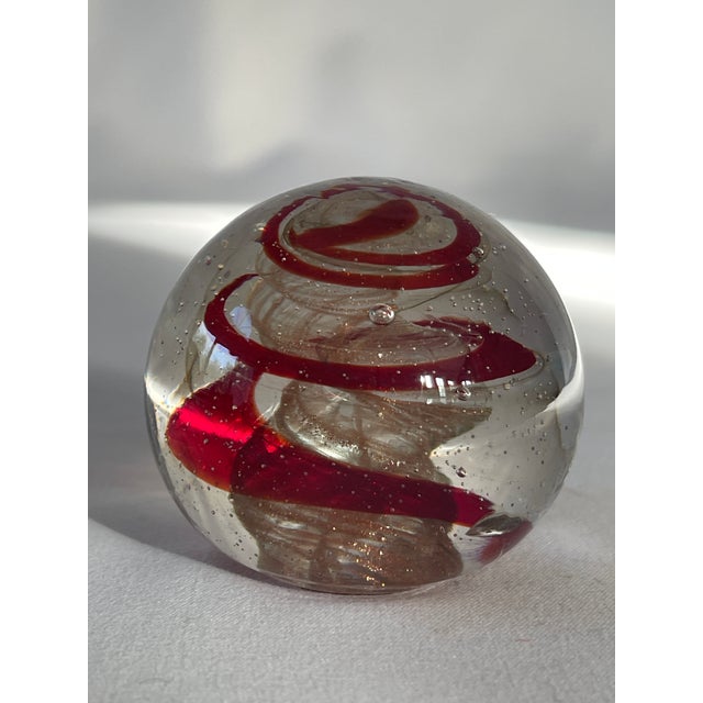 1960's Italian clear glass paperweight with red and gold aventurine swirl / spiral inclusion.