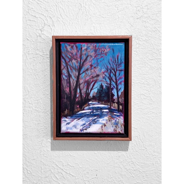 This mixed media piece captures a serene winter landscape, where snow blankets a pathway framed by trees adorned with...
