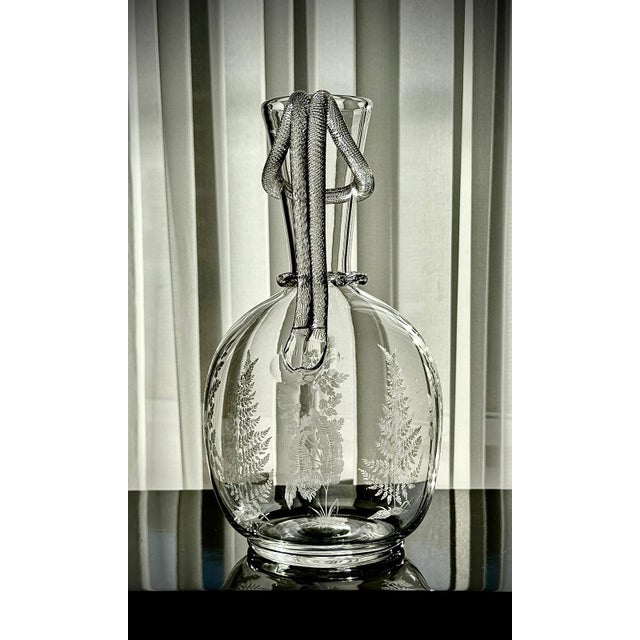 A finely executed Victorian etched glass amphora jug, crafted in England during the mid-19th century. This elegant piece...