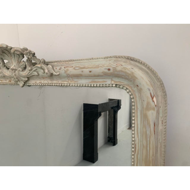 Wooden and stucco fireplace mirror with patina Beaded frame Attractive pediment decorated with flowers and foliage Good...