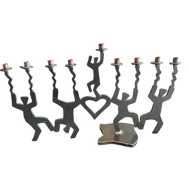 Dancing men figures in a cut steel art Menorah. Iron Steel construction. Inspired by Keith Haring modernist pop art....