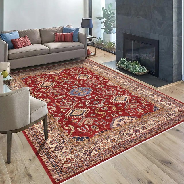 Enhance your home with this exquisite hand-knotted Super Kazak rug, crafted from fine hand-spun wool and dyed with all-...