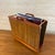 Ernest Sohn teak and rosewood veneer magazine rack for Siamese. The cutout handles and slim profile give it that clean...