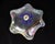 An art glass dish by American glass artist William Gottwalles. This flower-shaped dish has a ruffled edge and features...