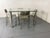 Rectangular Peter Ghyczy heavy chrome metal legs and thick Glass top Dining table or Desk. This piece has an attribution...