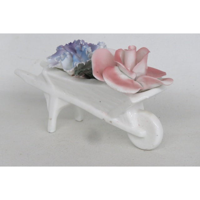 This gorgeous Floral Wheelbarrow Figurine is made of bone china. This darling collectible is marked on the bottom with the...