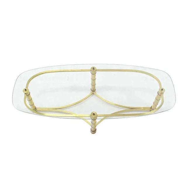 Mid-century modern brass faux bamboo motive base glass top coffee table. In style of Maison Bagues