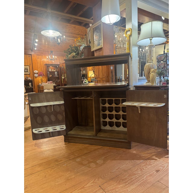 Vintage Dry Bar Cabinet with Mirrored back. Bar has 2 doors that provide lots of storage with wine bottle holders and...