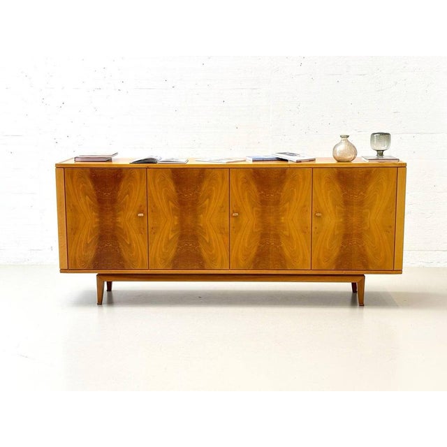 This sideboard is a classic example of high-quality European mid-century furniture and dates stylistically from the 1950s...