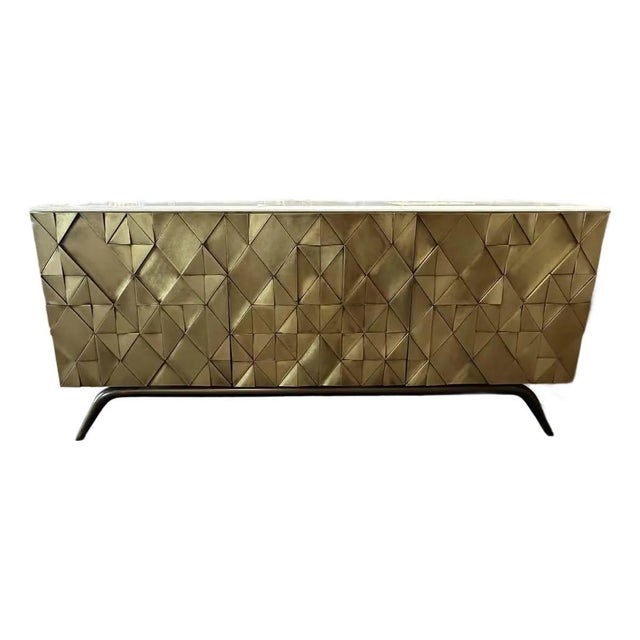 This amazing Global Views cabinet has a marble top and brass base. The triangular Shapes of MDF are hand clad using brass...