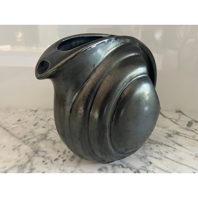 Fabulous shape, style, color. Wonderful unique gunmetal finish. I have a large collection of vintage ceramics and this is...