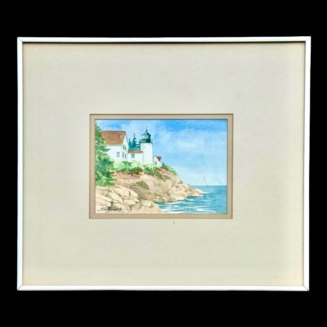 This vintage coastal watercolor by American artist Donna Sabaka (1946-) features the Bass Harbor Head Lighthouse, a...
