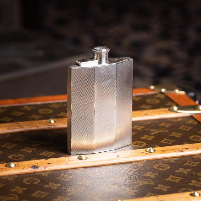 Vintage 20th century English solid silver hip flask of angular form, designed with clean geometric lines and engine-turned...