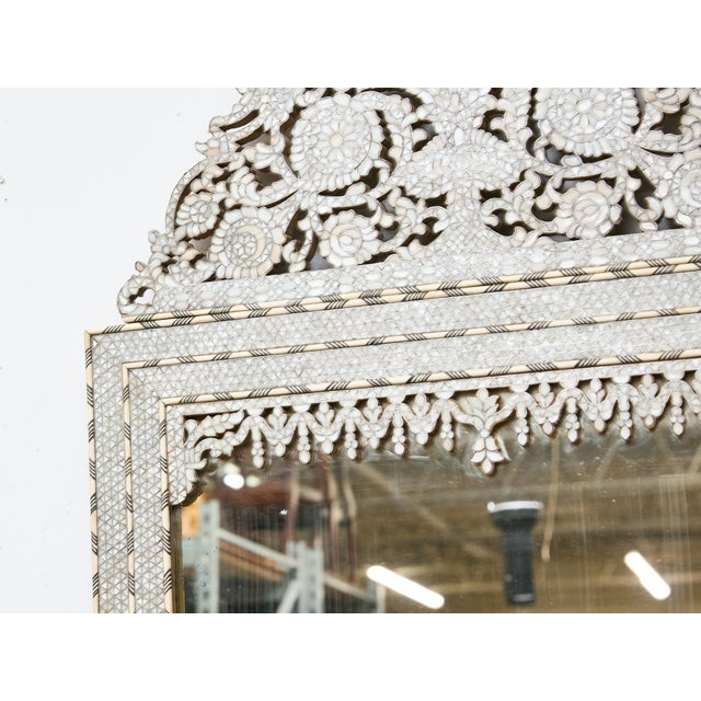 An exceptional Moroccan mirror dating to circa 1900, featuring a tall rectangular form surmounted by a distinctive arched...