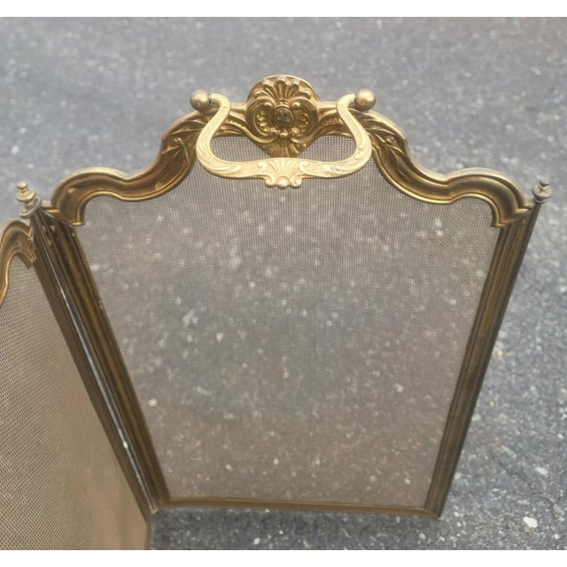 Antique French 4 Panel Brass Ornate Fireplace screen from the late 19th century. Decorative raised scenes on brass. Two...