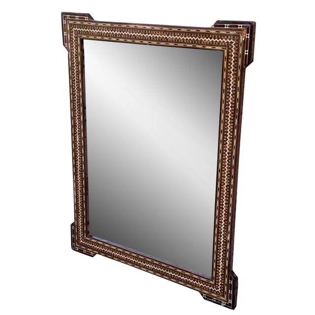 An exquisite mid 20th century Syrian mirror showcasing traditional mosaic inlay craftsmanship. The wooden frame is...