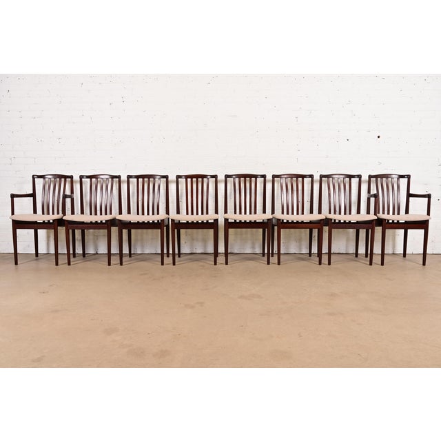 A sleek and stylish set of eight mid-century Danish Modern sculpted rosewood dining chairs By Vamdrup Stolefabrik Denmark,...