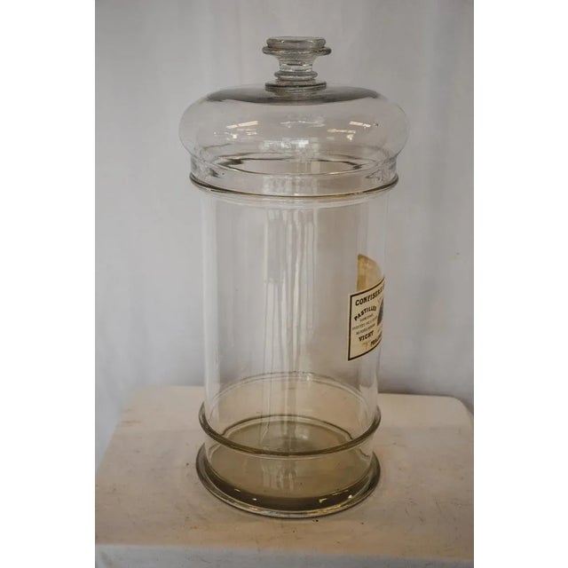 This large French Bon Bon jar is from a confectionary (candy shop) in France. The large glass jar features a rounded mouth...