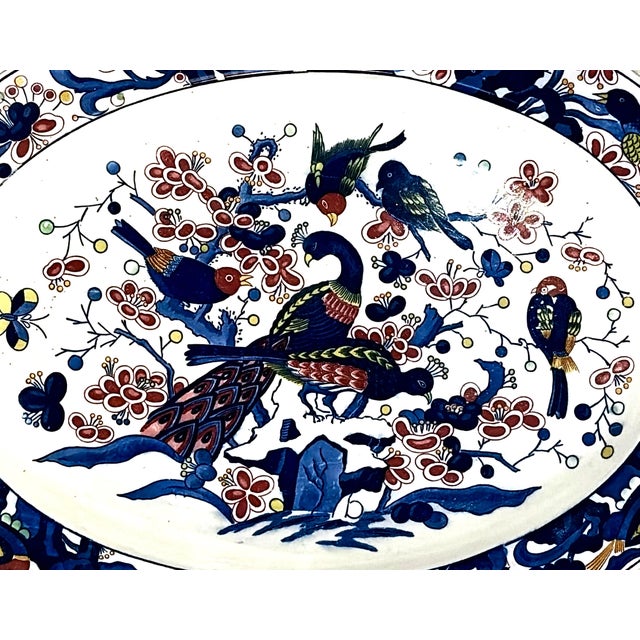 Japanese Imari-style ceramic serving platter featuring a hand-painted peacock, songbirds, and floral scrollwork on a...