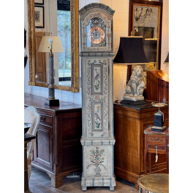Painted tall case clock with arched bonnet and glazed door enclosing a metal dial with Roman numerals and pierced...