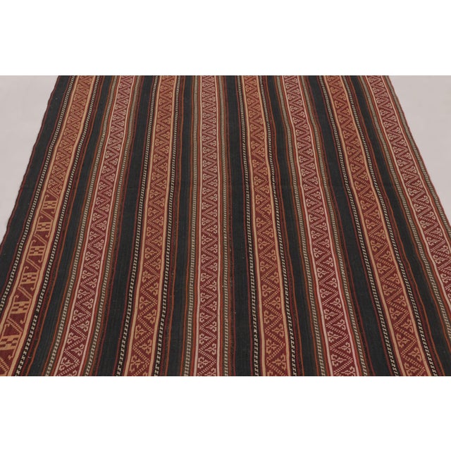 Handwoven in wool and originating circa 1950-1960, this 5x6 vintage Persian kilim is a newly curated tribal addition to...