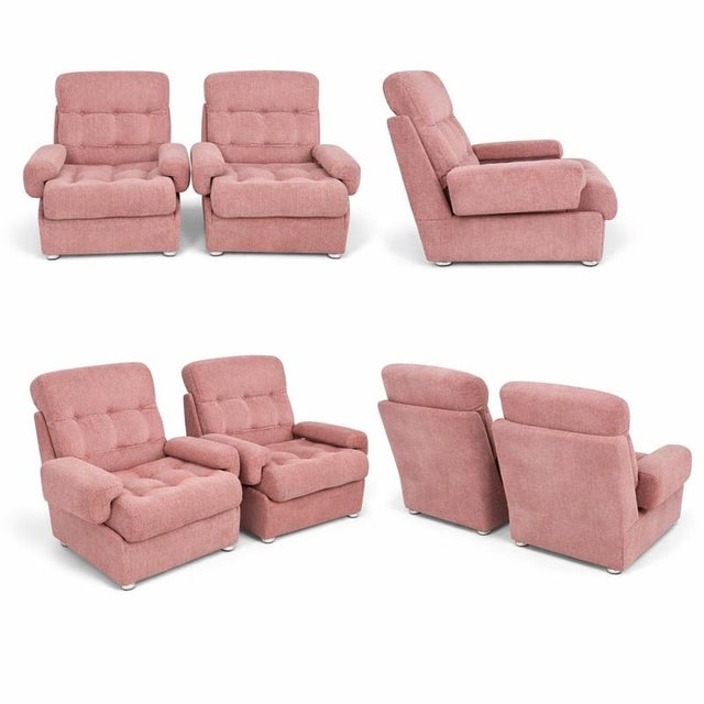 A striking pair of mid-century modular sofa armchairs, retailed by Heals, upholstered in a beautifully soft dusty pink...