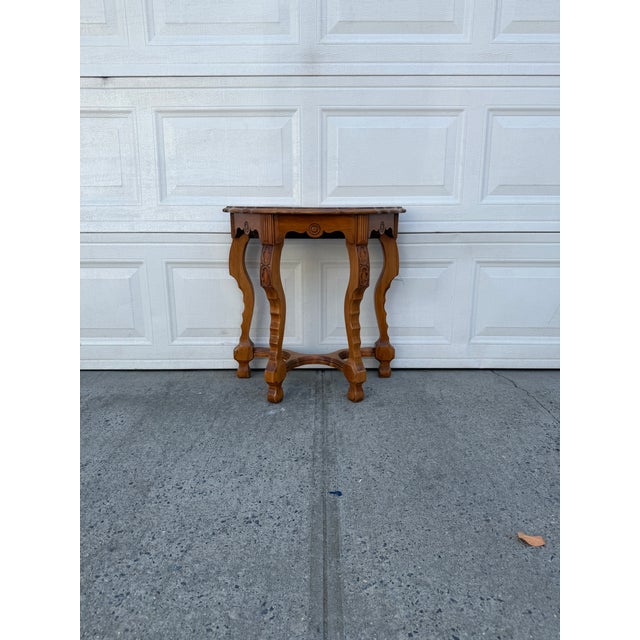 We have a beautiful vintage Italian style demilune console table for sale. It features an ornate sunburst veneer top,...