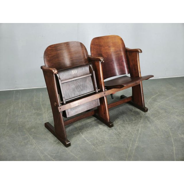 A rare original 2-seat cinema bench from 1920s Czechoslovakia, crafted from solid beech wood and shaped beech plywood....