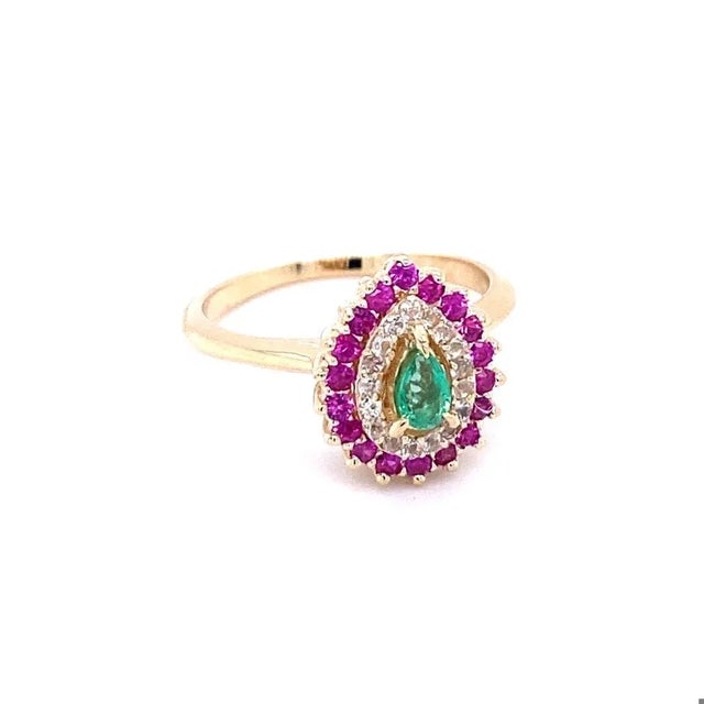 Emerald Sapphire 14 Karat Yellow Gold Cocktail Ring Delicate and dainty Emerald sits in the center of the ring and is...